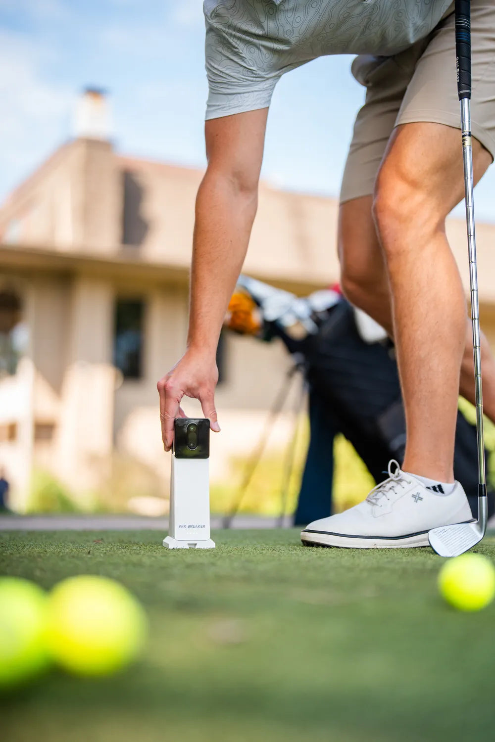 Golfer placing the X10 on a practice tee