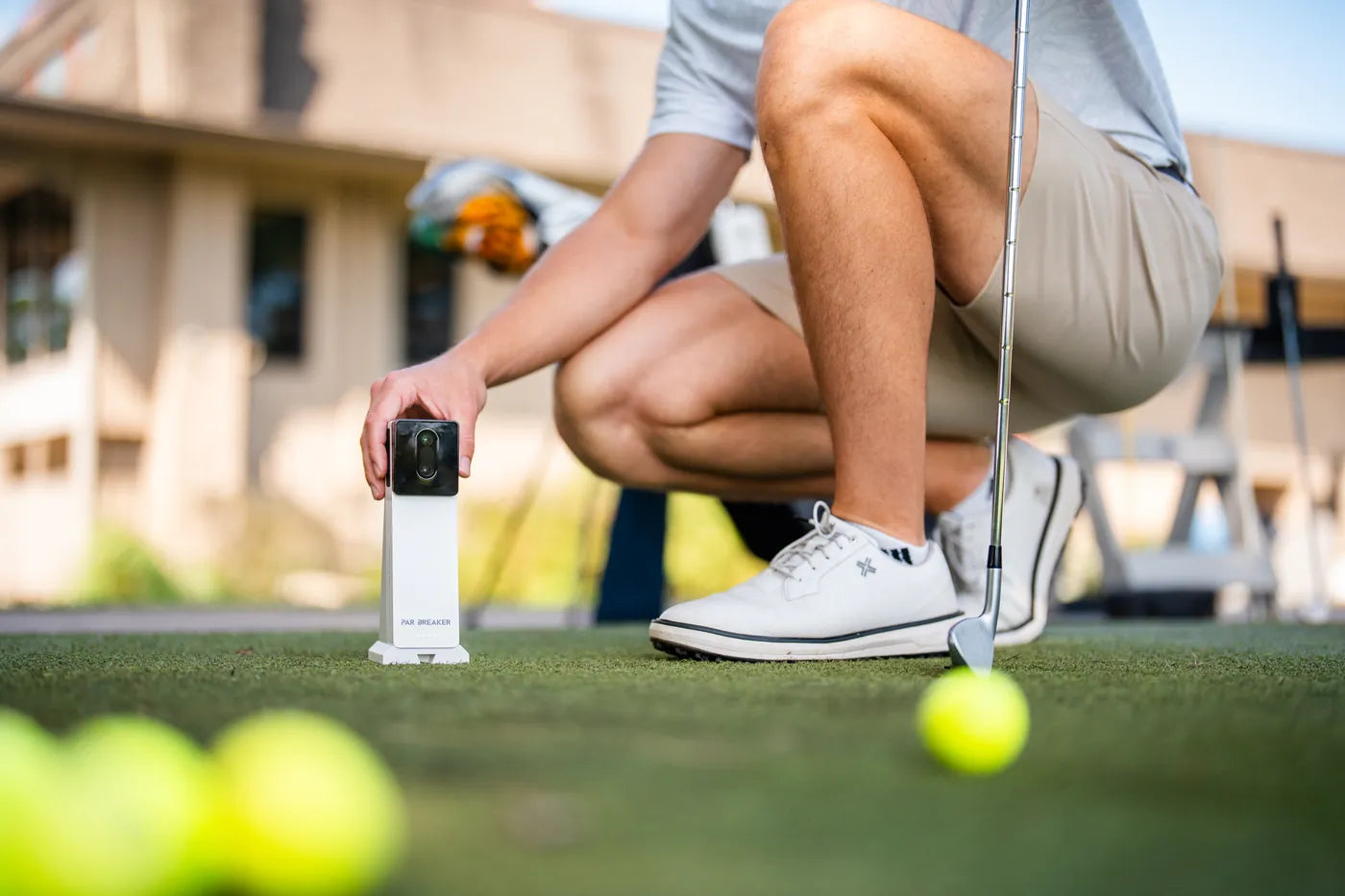 Golfer setting the X10 down on a practice tee