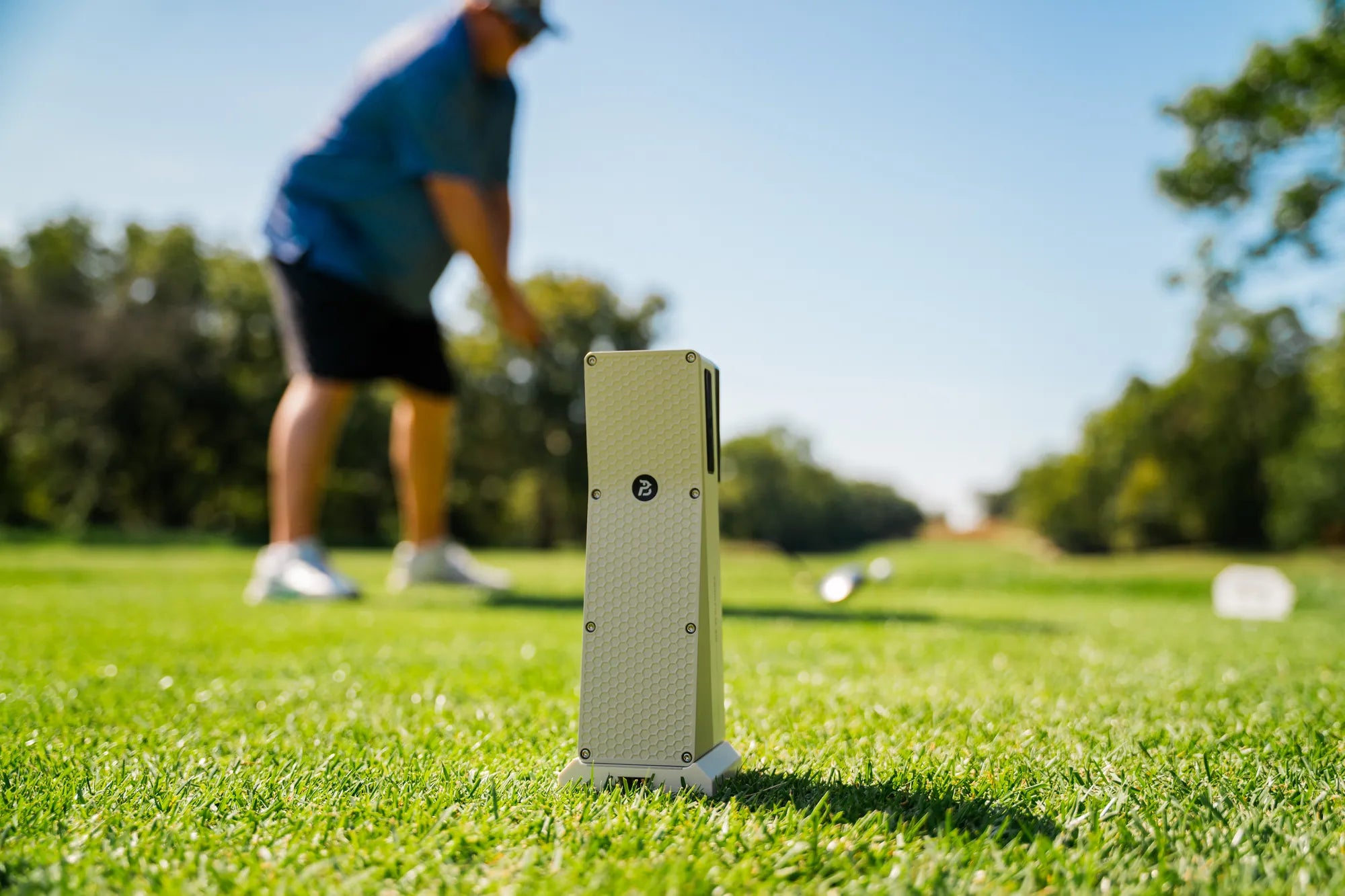 Golfer at address on the range with the X10 set up behind him